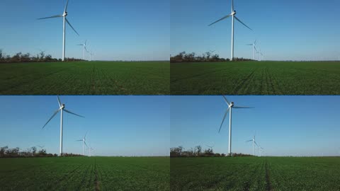 在绿色麦田上空旋转风车