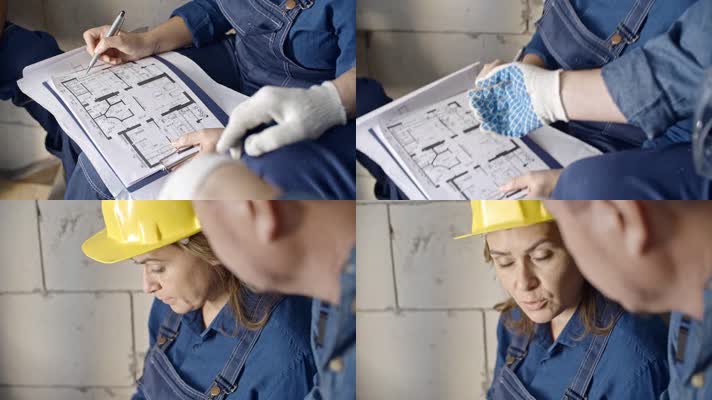 建筑工人讨论设计图纸  安全帽 
