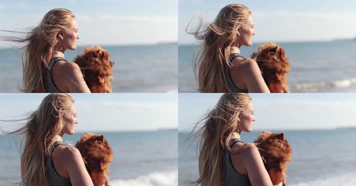 美女手抱宠物狗站在海边 4K实拍视频