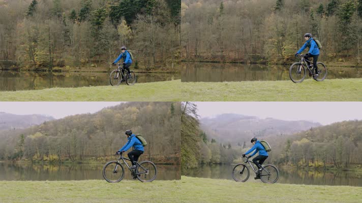 年轻男子骑山地自行车 山林水塘