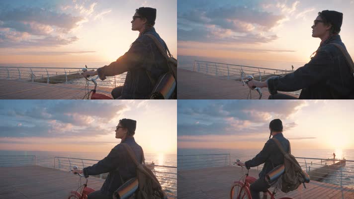 迎着夕阳海边骑自行车的美女