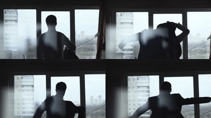 成功男士窗前穿衣服