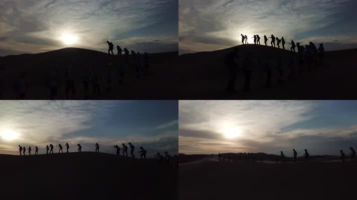 团队在沙漠中努力前进的剪影