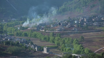 掩映在大山树林里的村庄和袅袅炊烟