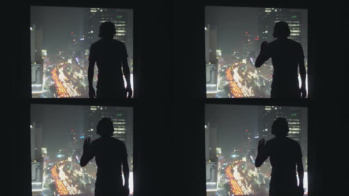 窗外城市夜景男人剪影