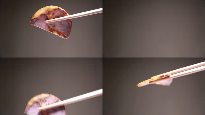 筷子夹起一片熟食卤肉 (2)