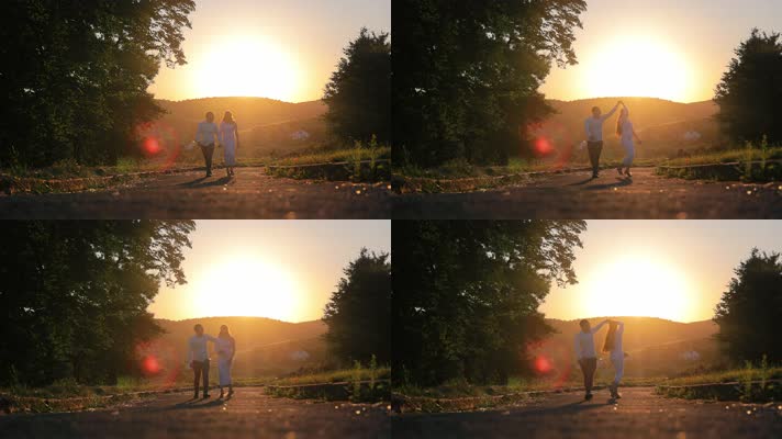 一对夫妇在日落时沿着小路跳舞