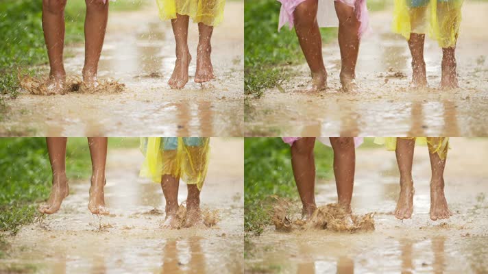 两个赤脚小孩雨衣跳起踩水
