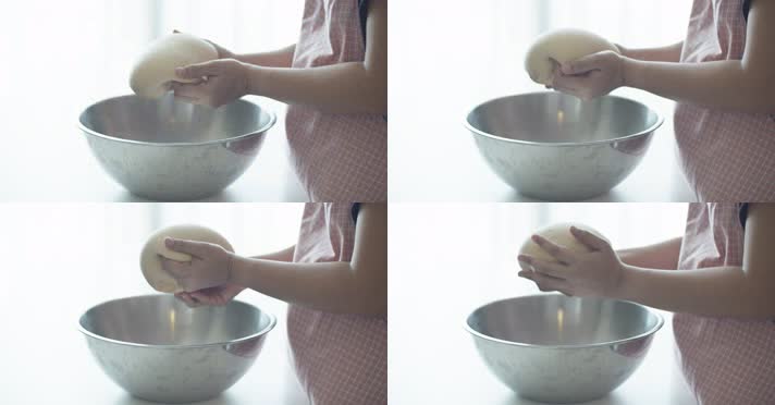 女人在不锈钢碗上用手揉面团慢镜头4k