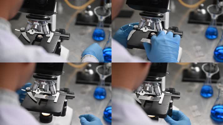 年轻的科学家在实验室里通过显微镜观察正在
