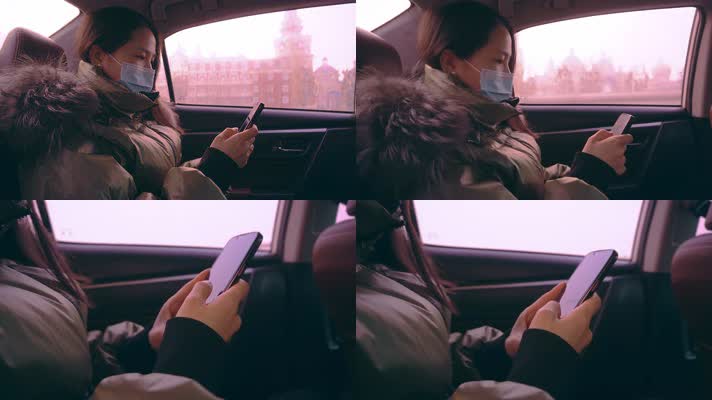 女子冬天坐车玩手机