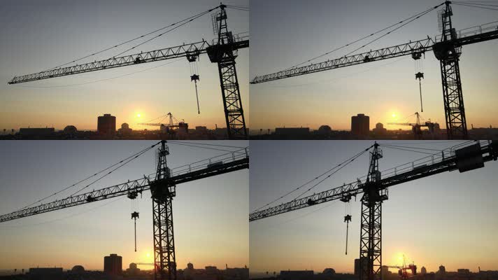 夕阳下的城市建筑起重机塔吊
