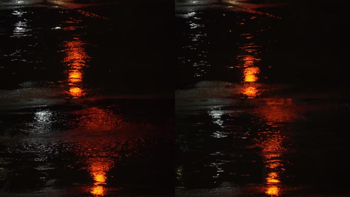 路面溅起水花雨滴红绿灯倒影