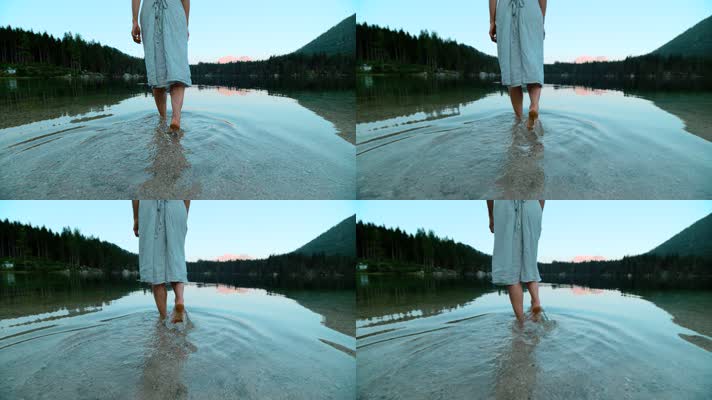 女孩的脚躺在冰凉的湖水里