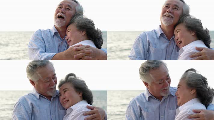 两位老人站在海滩上拥抱