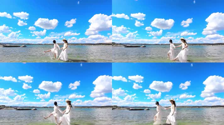 4k两个穿白裙的女孩在蓝天白云海边漫步