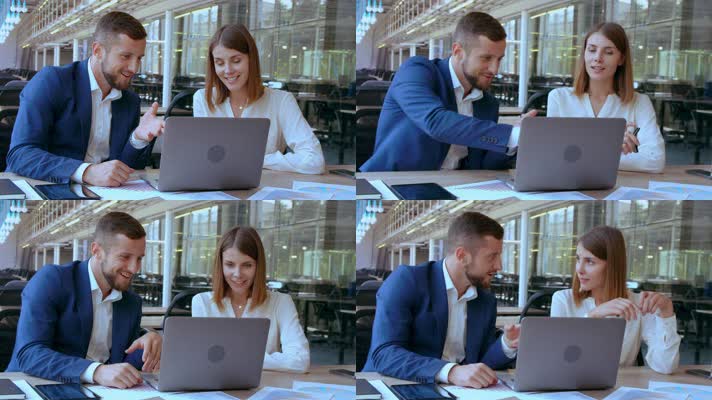 商务男士女士面对笔记本电脑洽谈商议