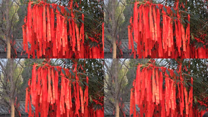 寺庙里在微风中飘动的红色祈福带