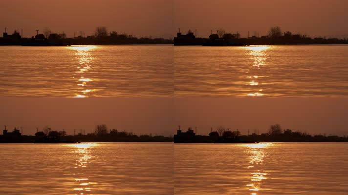 傍晚夕阳落日逆光金色水面轮船剪影