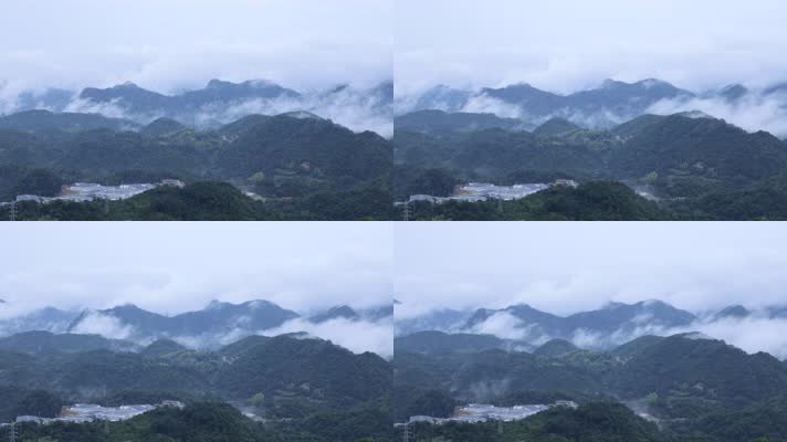 高山俯视山峰云层云雾缭绕下的工厂与村落