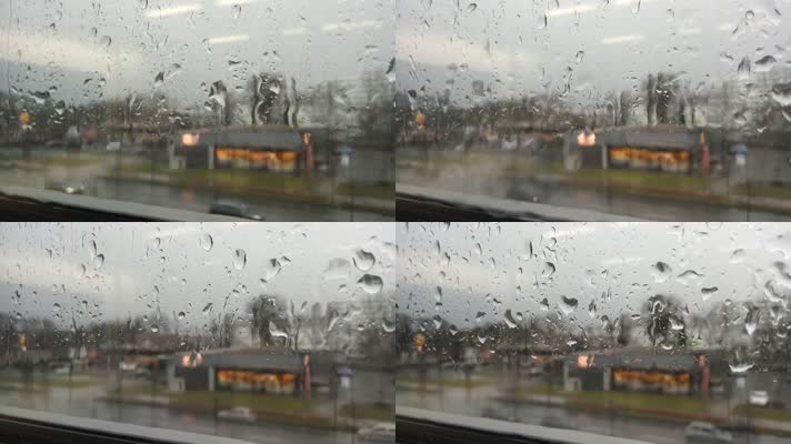 隔着玻璃看马路上的大雨和车辆