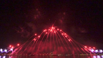 节日氛围红色背景烟花飞向半空绽放