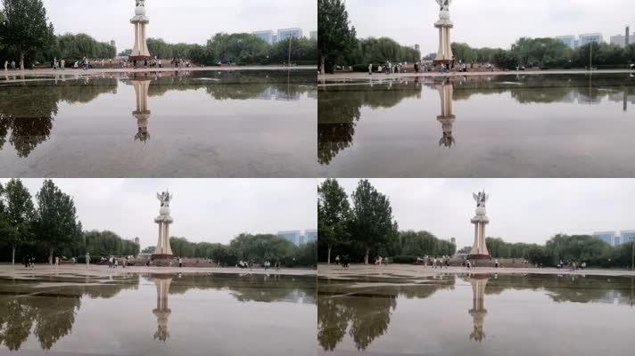公园游人广场积水倒影